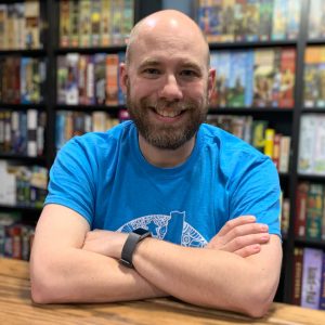 Nerd in front of board games.